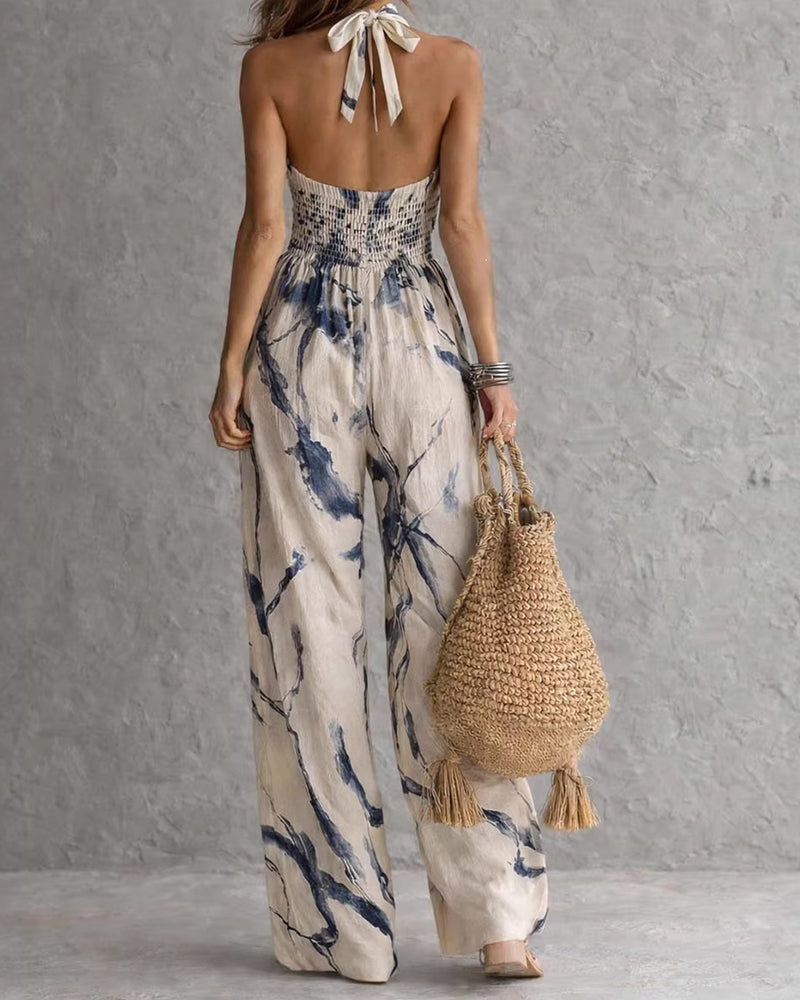 Elvina - Dames jumpsuit met halternek en aquarelprint